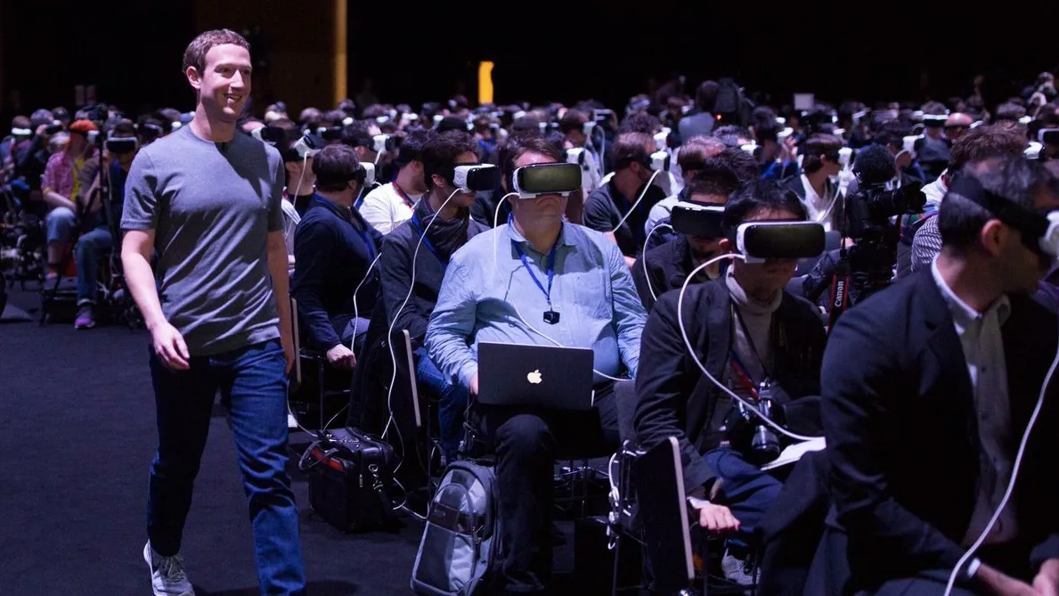 Mark Zuckerberg walking past a large audience wearing virtual reality headsets